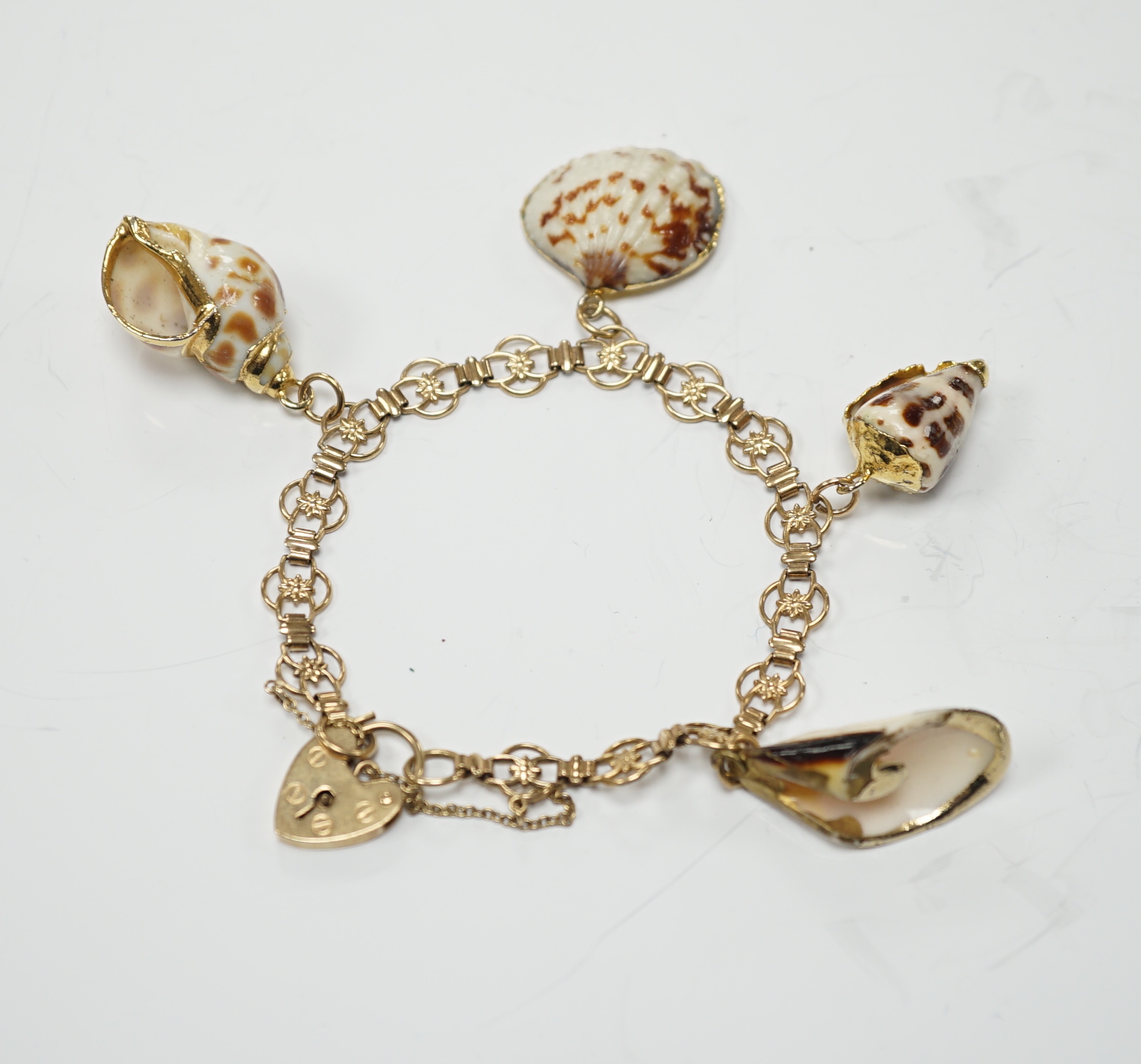 A modern 9ct gold charm bracelet hung with four shell charms, gross weight 19.1 grams.